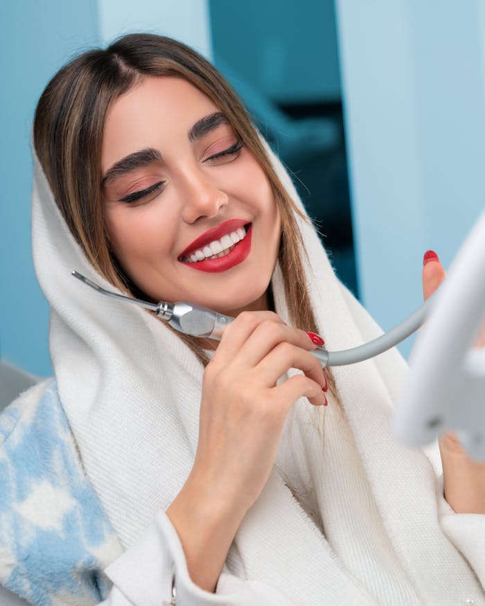 Young Woman Holding a Dental Instrument and Smiling 